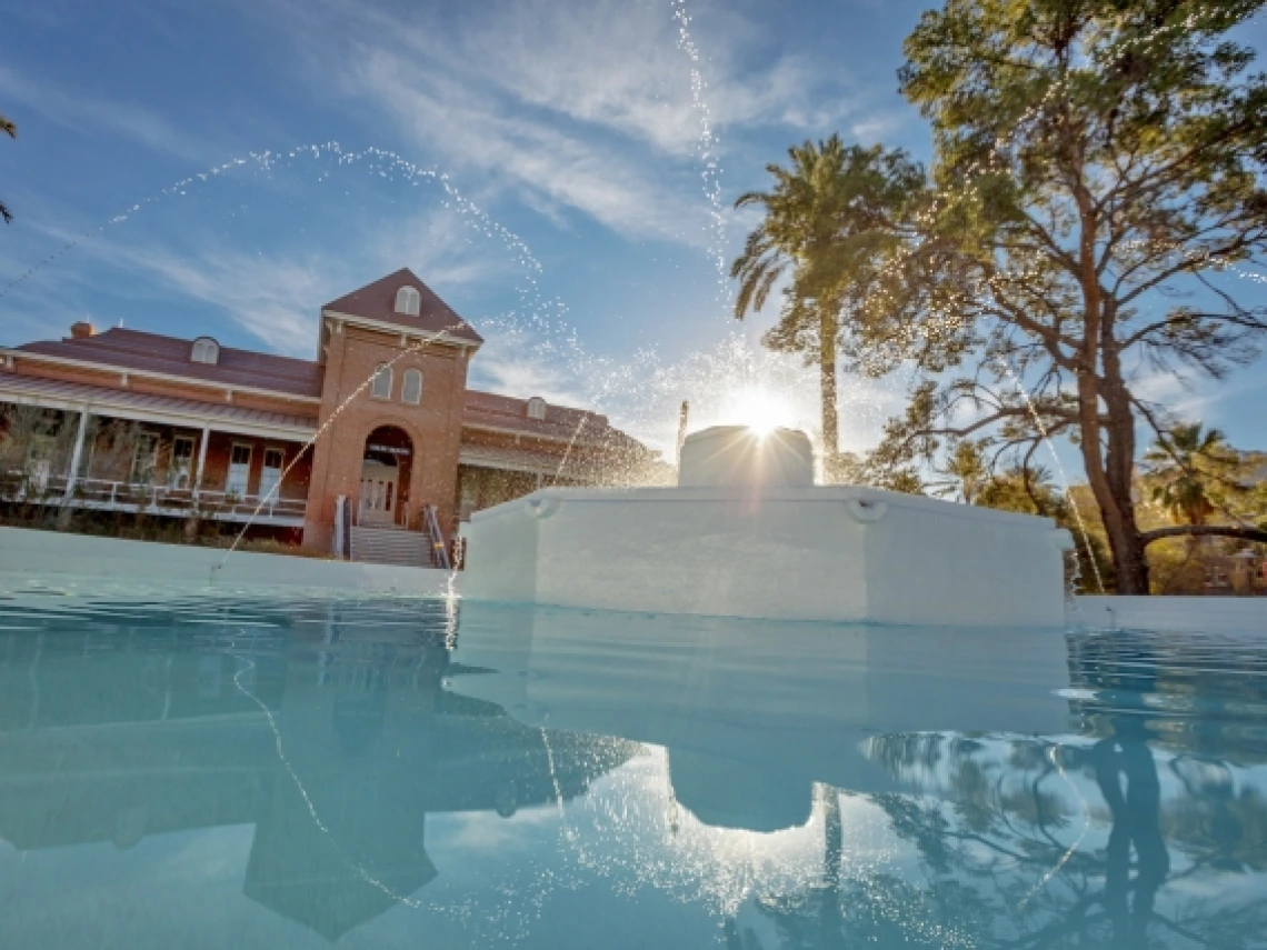 old main rises above the berger memorial fountain