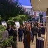 Several people gather at a reception in a courtyard outside the Andrew Weil Center for Integrative Medicine